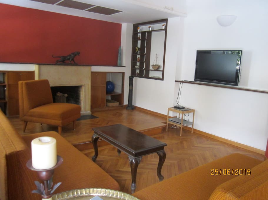 Large sitting room with TV set, DVD set, fire place and long beautiful balcony.