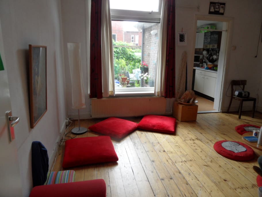 Living room with window to garden and door to kitchen