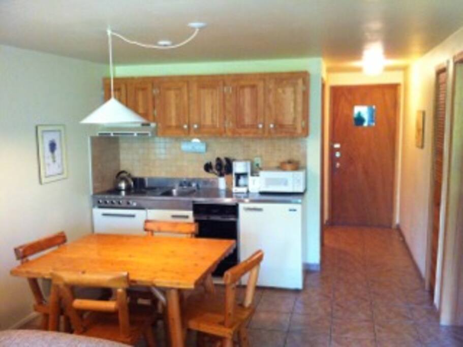 Full kitchen including dish washer, dishes, pots and pans.