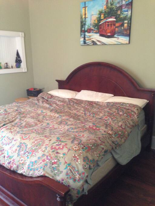 King sized bed in the bedroom. French doors open up to the patio.