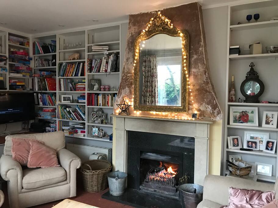 Sitting room with open log fire. Perfect place to snuggle up talk and play games