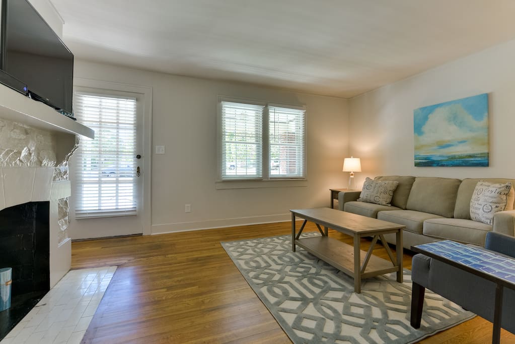 There's plenty of sunlight and cozy seating in the living room.