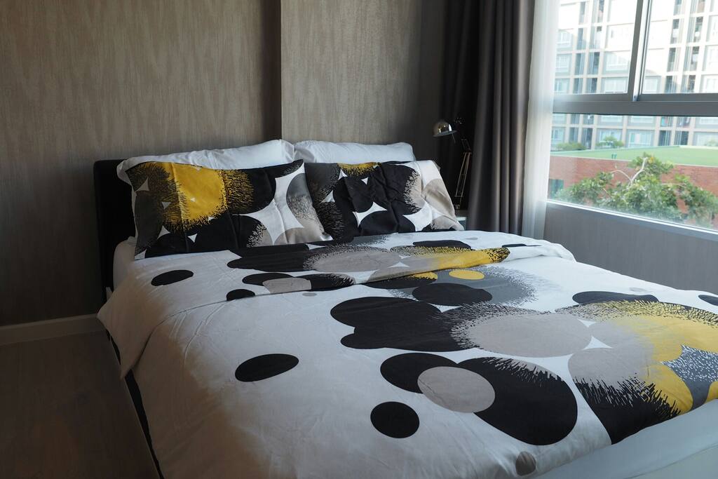 Comfortable bed with clean pillows and duvet