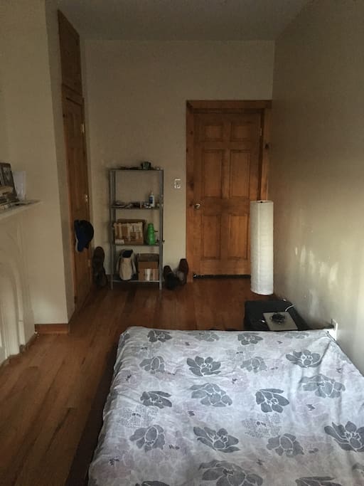 View of bedroom door. Closet to the left. That storage rack will be empty for your stay.