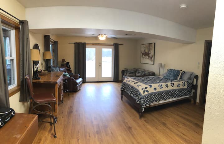 This bedroom is in the bottom of the Bunkhouse next to the game room. It now has a king bed instead of the full bed shown. This room has a bathroom that joins it. It has a door to the right of the bed going into the gameroom. It also has a river view