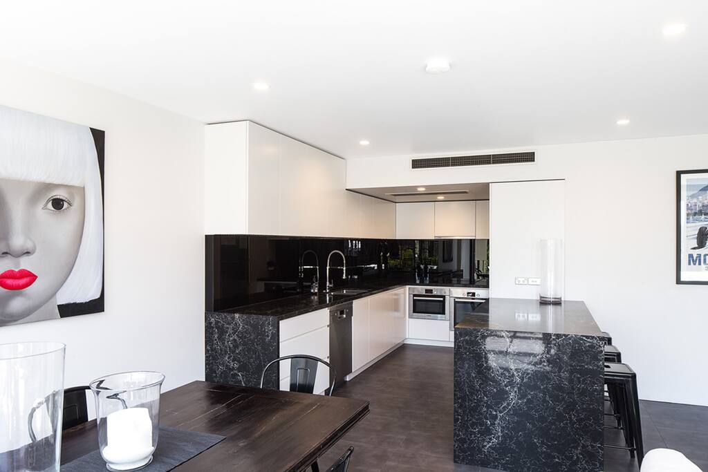 Large well appointed kitchen with European appliances and stone bench tops.