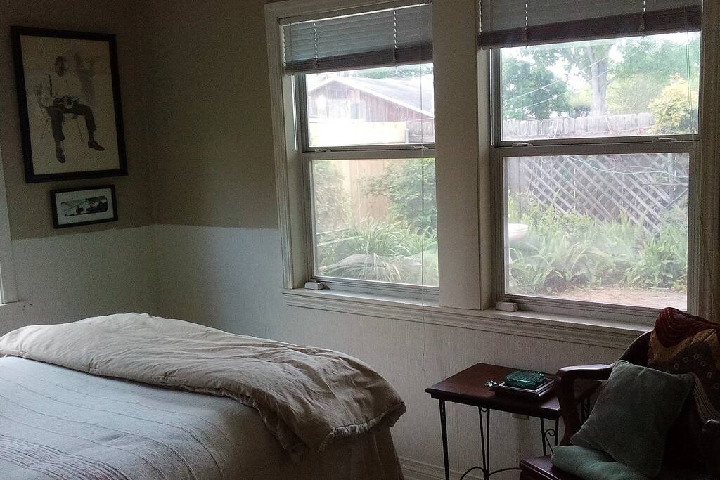 Bedroom windows overlook private patio.