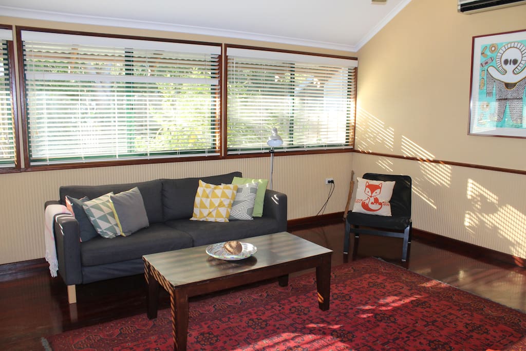 Lounge room with couch, TV, DVD and board games