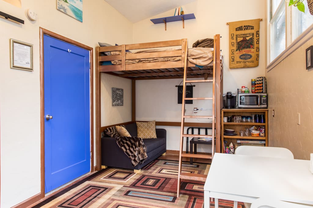 Full size loft bed above, love seat below that folds out to a foam mattress for a child or young adult.