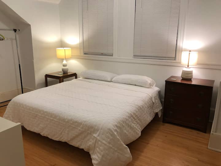 Cama king con mesita de noche y cómoda