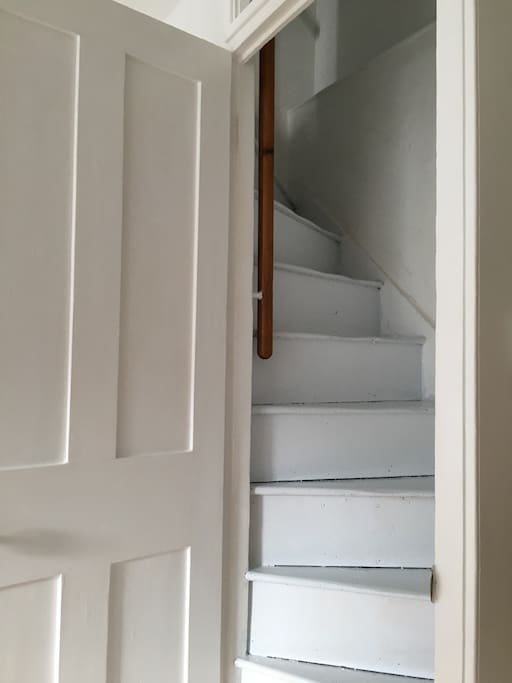 beautiful original stairs with door to close from lounge.