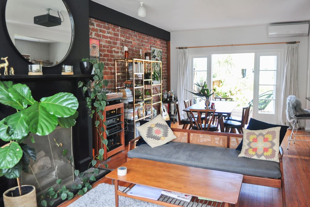 Open plan living space and sunny tropical garden