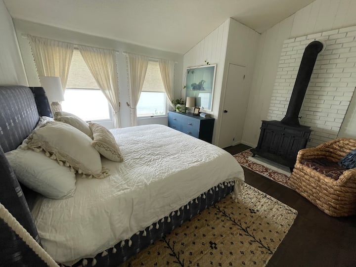 King-size bed in the main upstairs bedroom. (Non-working fireplace.)