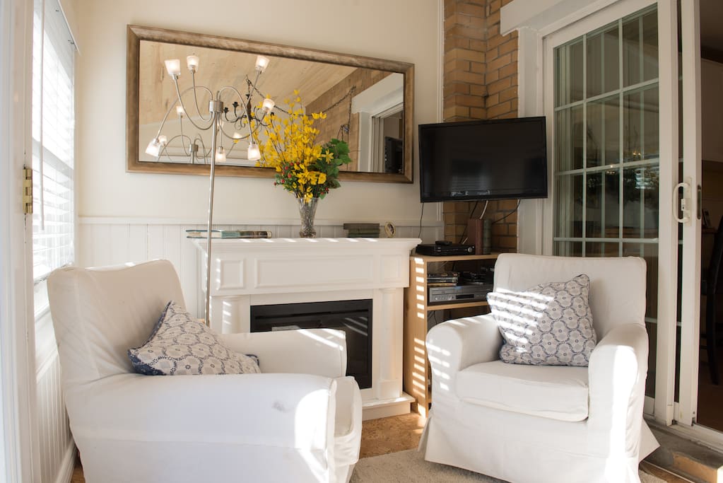 Sunroom. Bright and comfortable. Great place to read a book and relax- cottage feel in the city.