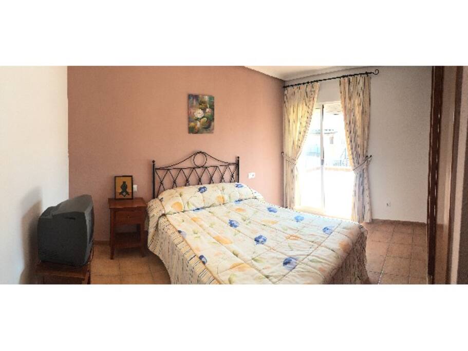 Dormitorio independiente con cama de matrimonio y armario empotrado, acceso a la terraza