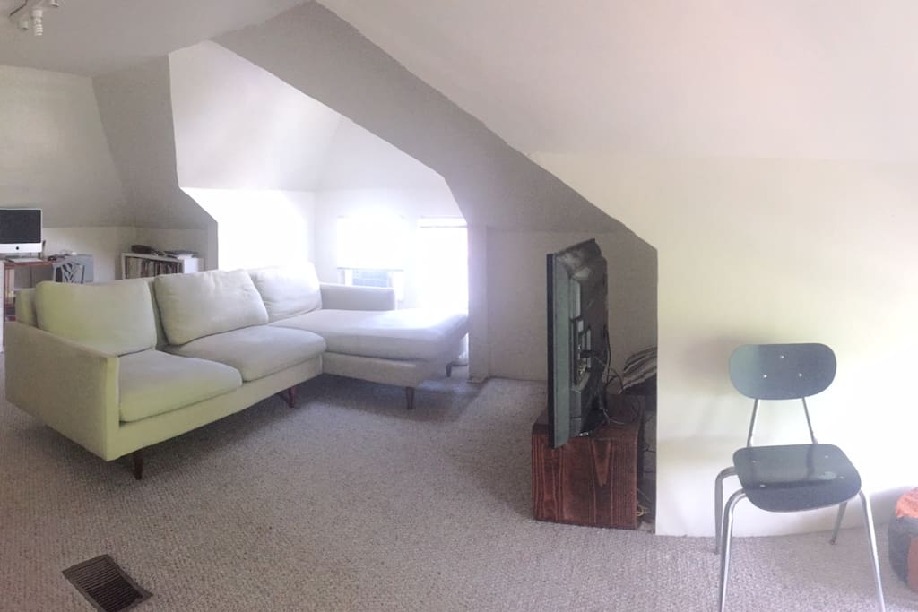 There is an attic level room with a smart TV, extra mattress, and desk space for getting work done.