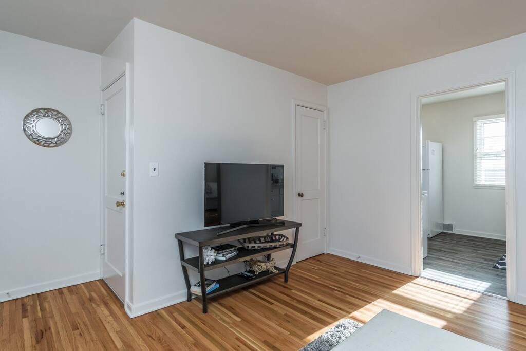 living room with 43 inch smart tv and 2 closets