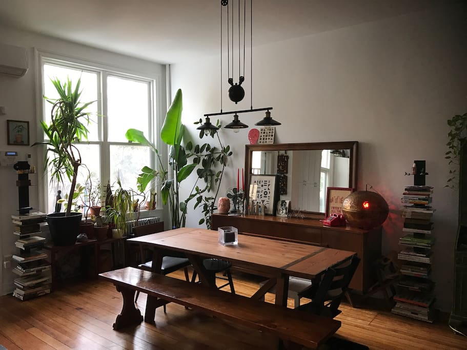 Light filled dining room with farm table.