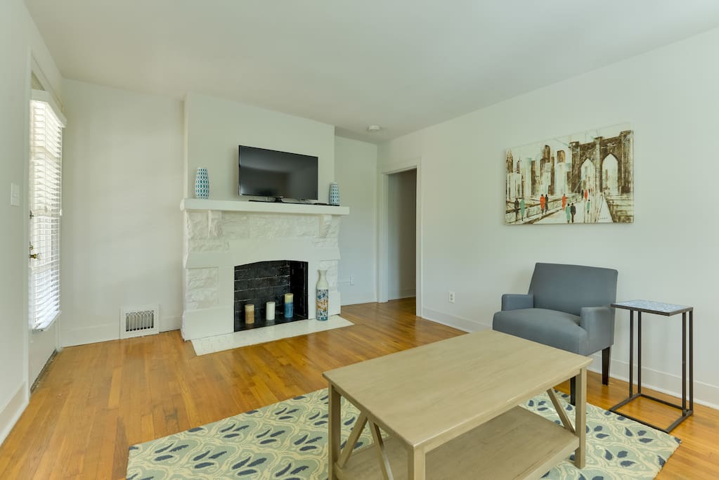 Hardwood floors and a decorative fireplace adorn the living room
