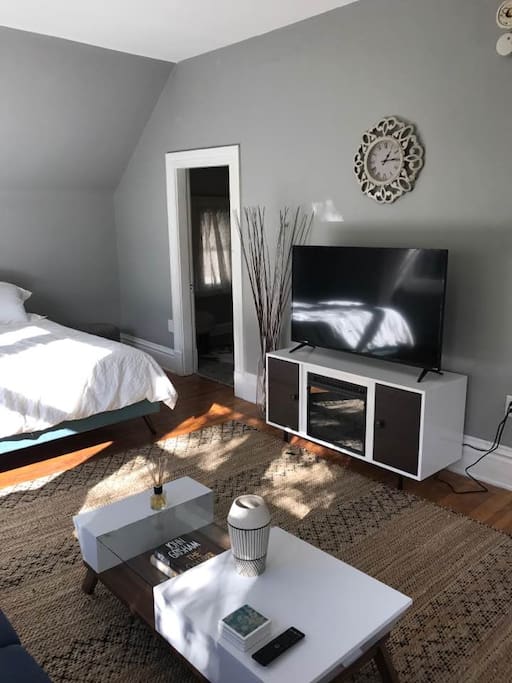 Living space with bed, futon, fireplace and Tv.