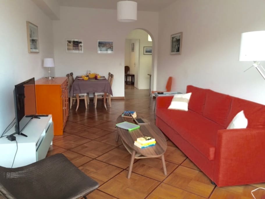 Large and comfortable living and dining area with a sofa bed
