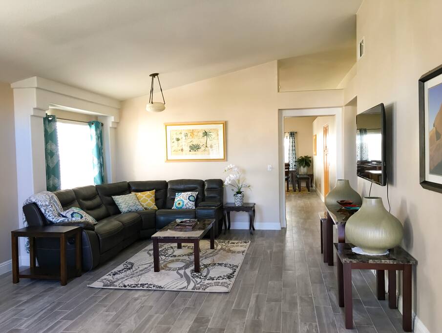 living room with comfortable seating & 65" smart tv