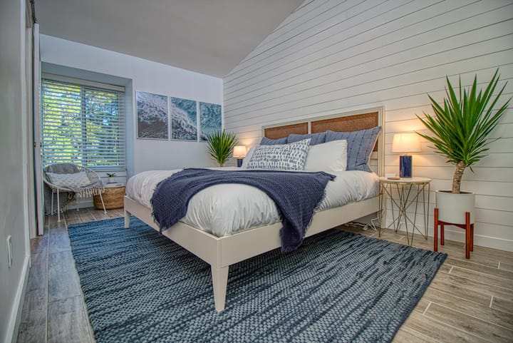 Loft-style bedroom with contemporary, coastal vibes.