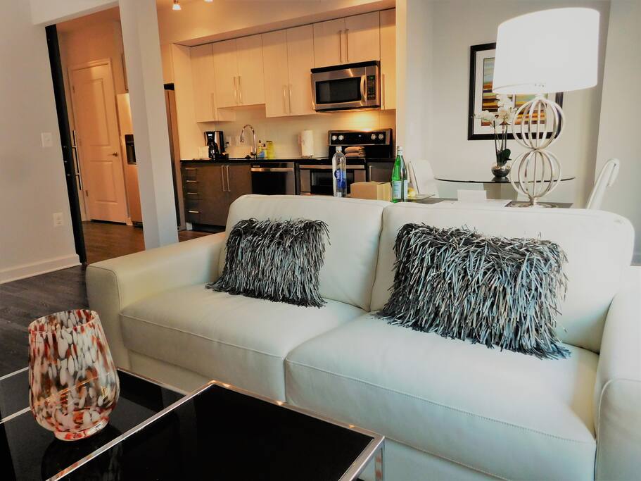 Sink into this luxe white leather couch after a long day at the office or sightseeing.