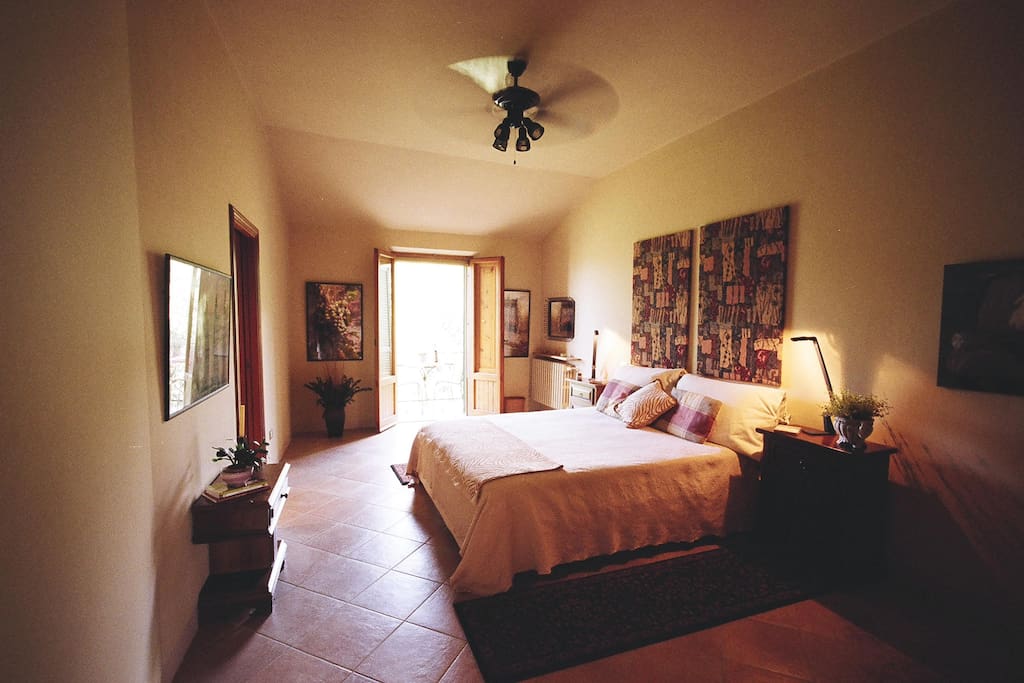 Bedroom with king size bed and french doors opening to balcony
