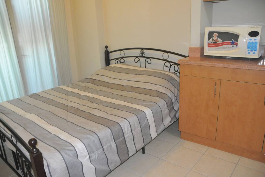 Queen size bed and Microwave also available at the kitchen, refrigerator, kitchen ware available