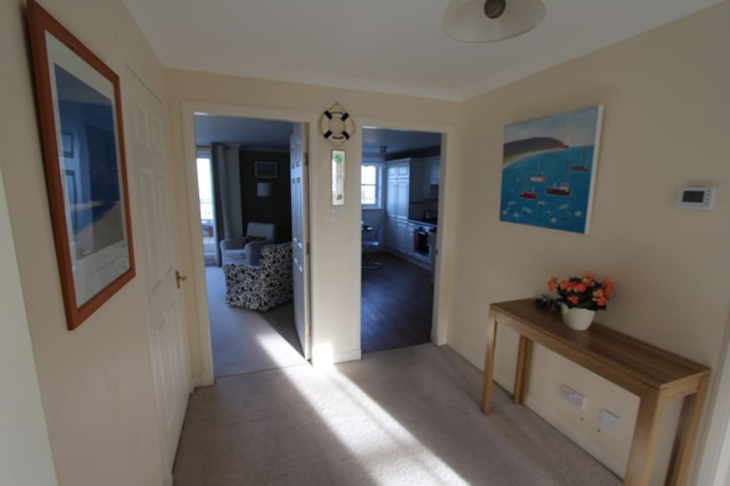 the hall looking to living room and kitchen