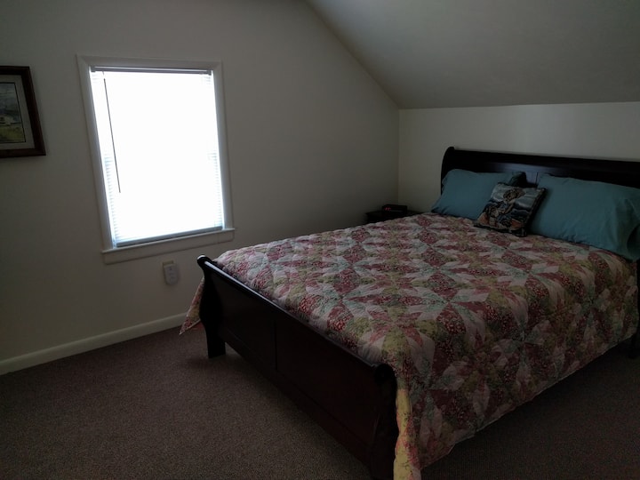 Back Bedroom with Queen Bed, Dresser with Mirror, Nightstand with Clock Radio and two closets