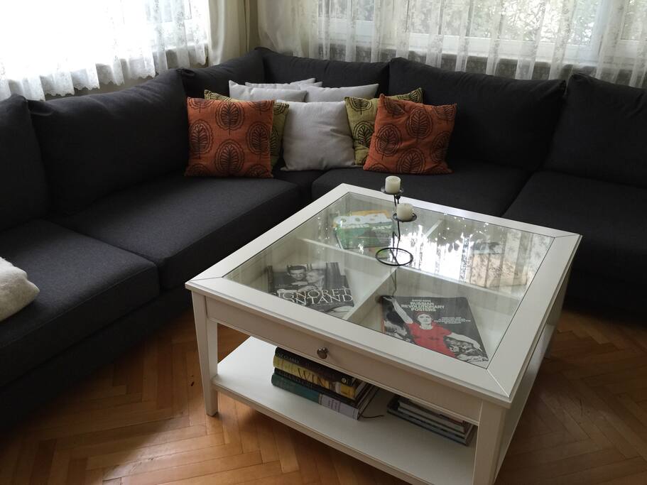 Comfortable seating area in living room with plenty of coffee table books to browse