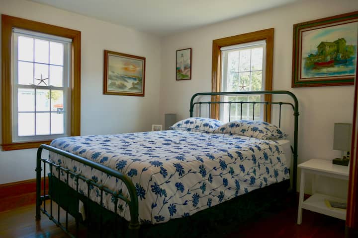The back bedroom facing northeast with a brand new pillow top queen mattress on a metal frame with box spring. 