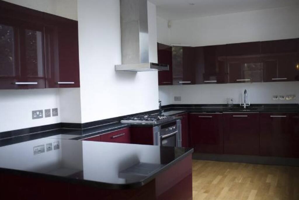 Large, modern kitchen with washing machine and dishwasher