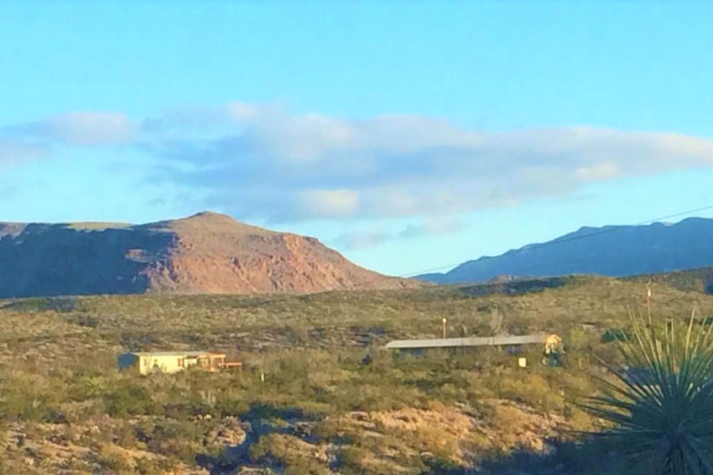 Vacation rental as seen from the Hot Spring Road. Owner’s home on right; guest house on left.
