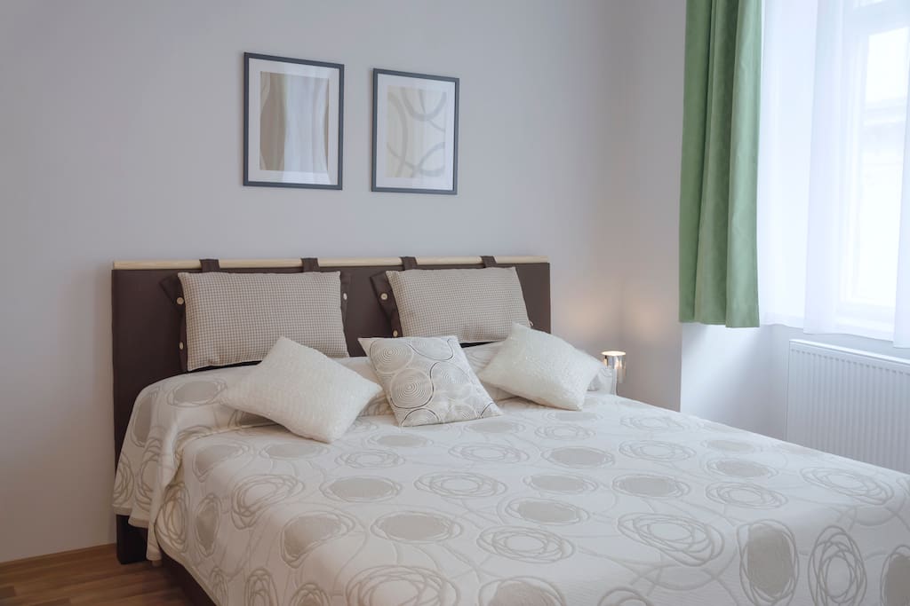Living room with king size bed for two person, foldout sofa for two person and recliner chair for one person.