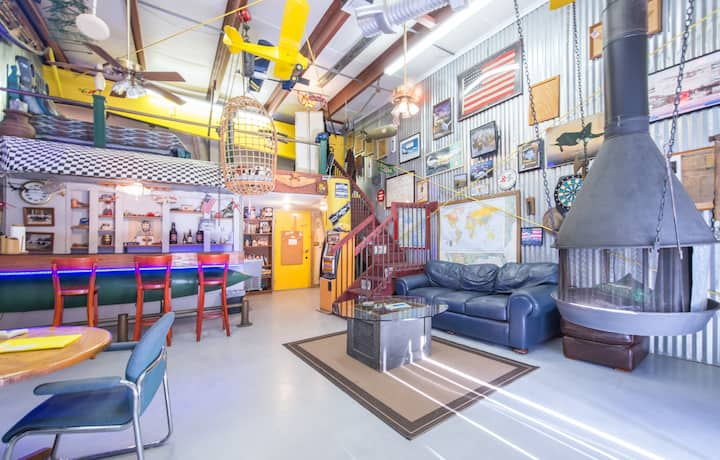 Man Cave, a retro-inspired and colorful AirBnB to stay while traveling featuring vintage car parts and corrugated metal accents.