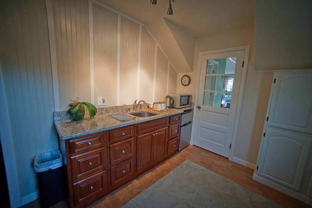 Adjoining kitchenette with small fridge and microwave.