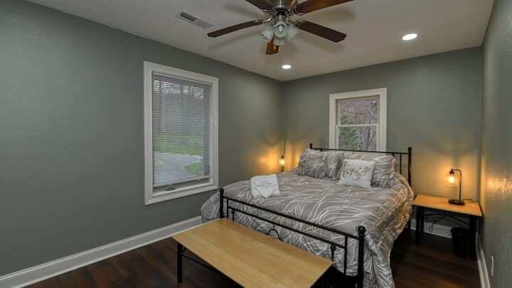 The front bedroom with a comfortable bed, a table upon which to place your luggage and two dimmable lamps with USB ports for phone charging.