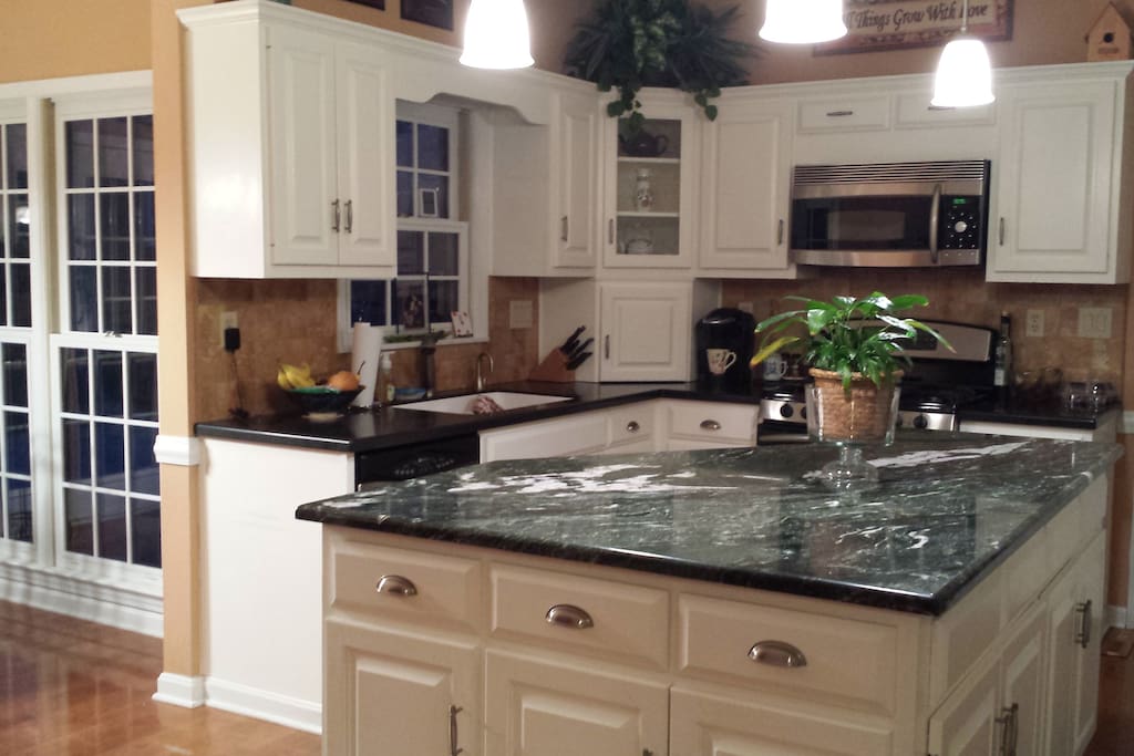 Modern kitchen features stainless appliances.