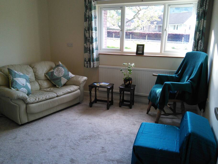 Sitting room with sofa, chairs and single chair-bed