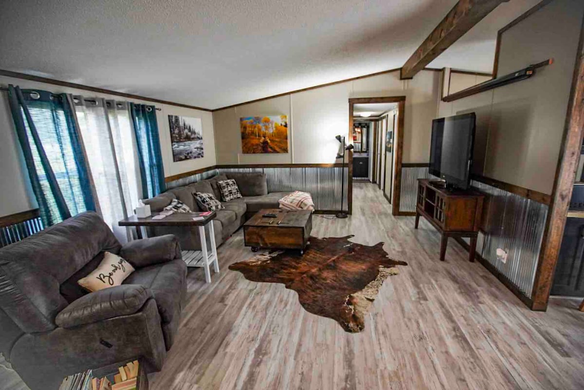 Living room with vaulted ceilings and open concept into the dining area 