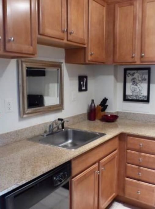 Fully equipped kitchen with gas stove, microwave and ice maker.