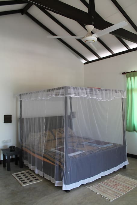 king-size double bed with mosquito net