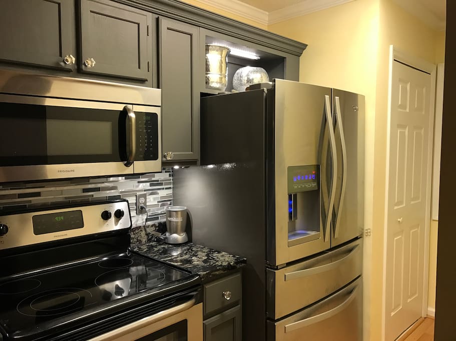All stainless steel appliances, under counter lighting, microwave, quiet dishwasher, self cleaning oven, French door style refrigerator, K-cup coffeemaker, and well appointed cooking utensils & dishes.