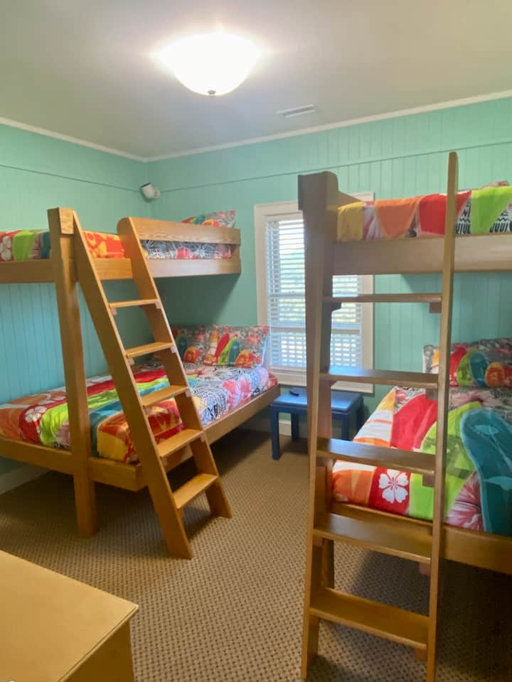 2nd floor bedroom level.  Double bunk beds (triple twin and one full) with en suite - Surfboard room.