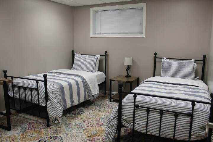 Second bedroom with two twin sized beds is great for sleeping two people! The room also features a small study desk, large closet, 4 drawer dresser, additional linens, etc. 