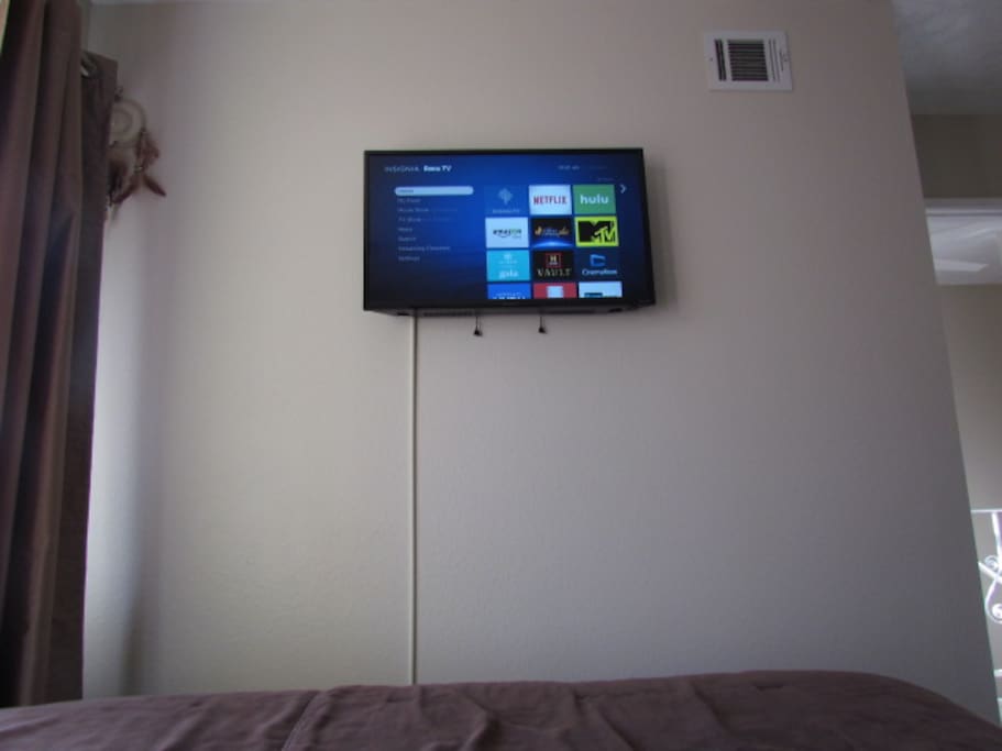 You have a smart TV at the foot of your bed. With access to Netflix, Amazon and Hulu to name a few!