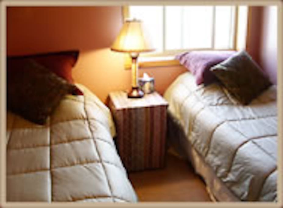 Two single beds in the second bedroom .